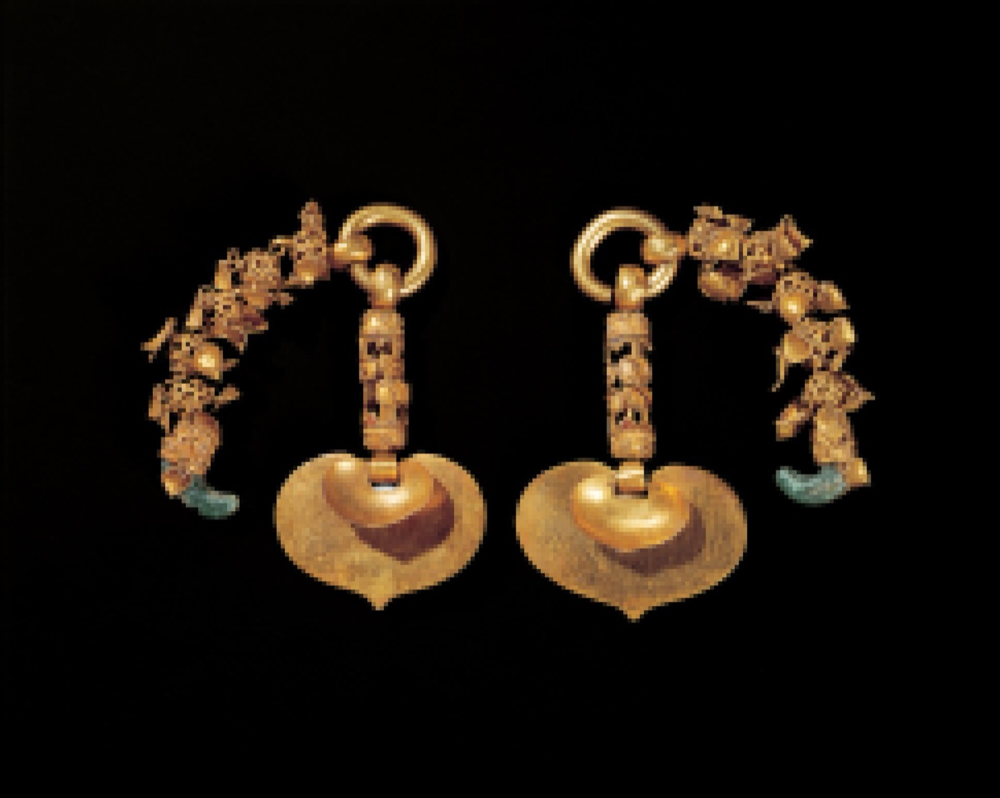 The king’s gold earrings from the tomb of King Muryeong in Gongju: from each ring hang a long chain of small ornaments and a large heart-shaped plate. Baekje men as well as women wore earrings.