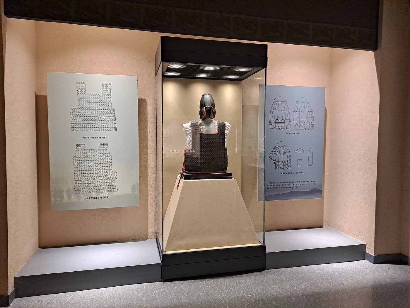 Reconstructed iron lamellar helmet and armour based on finds from Tomb 97 at Laoheshen, displayed at the Jilin Provincial Museum with drawings of the original plates. It shows that Buyeo warriors already wore lamellar armour.