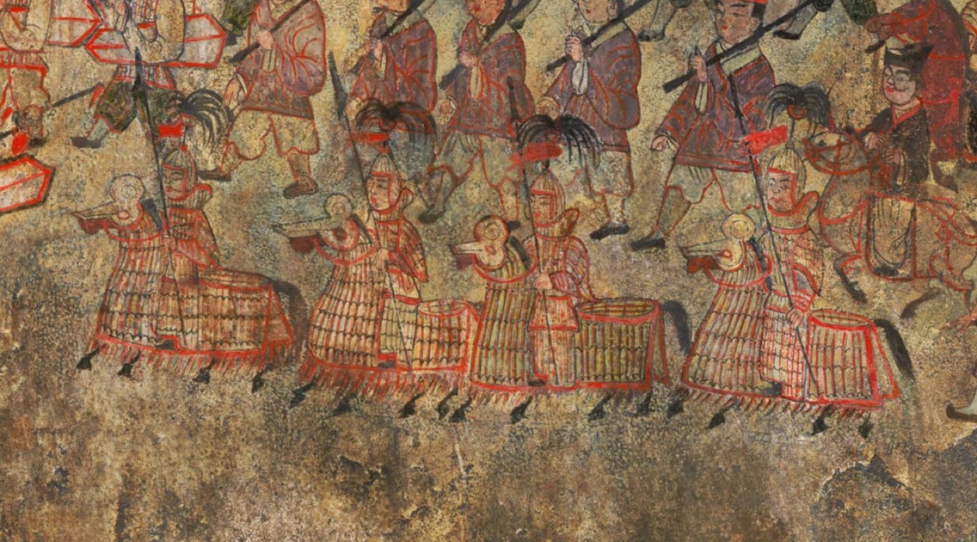 Detail of the great procession in Anak Tomb No. 3: soldiers in long lamellar coats and plumed helmets march with spears and large shields. The same procession includes armoured riders on armoured horses.