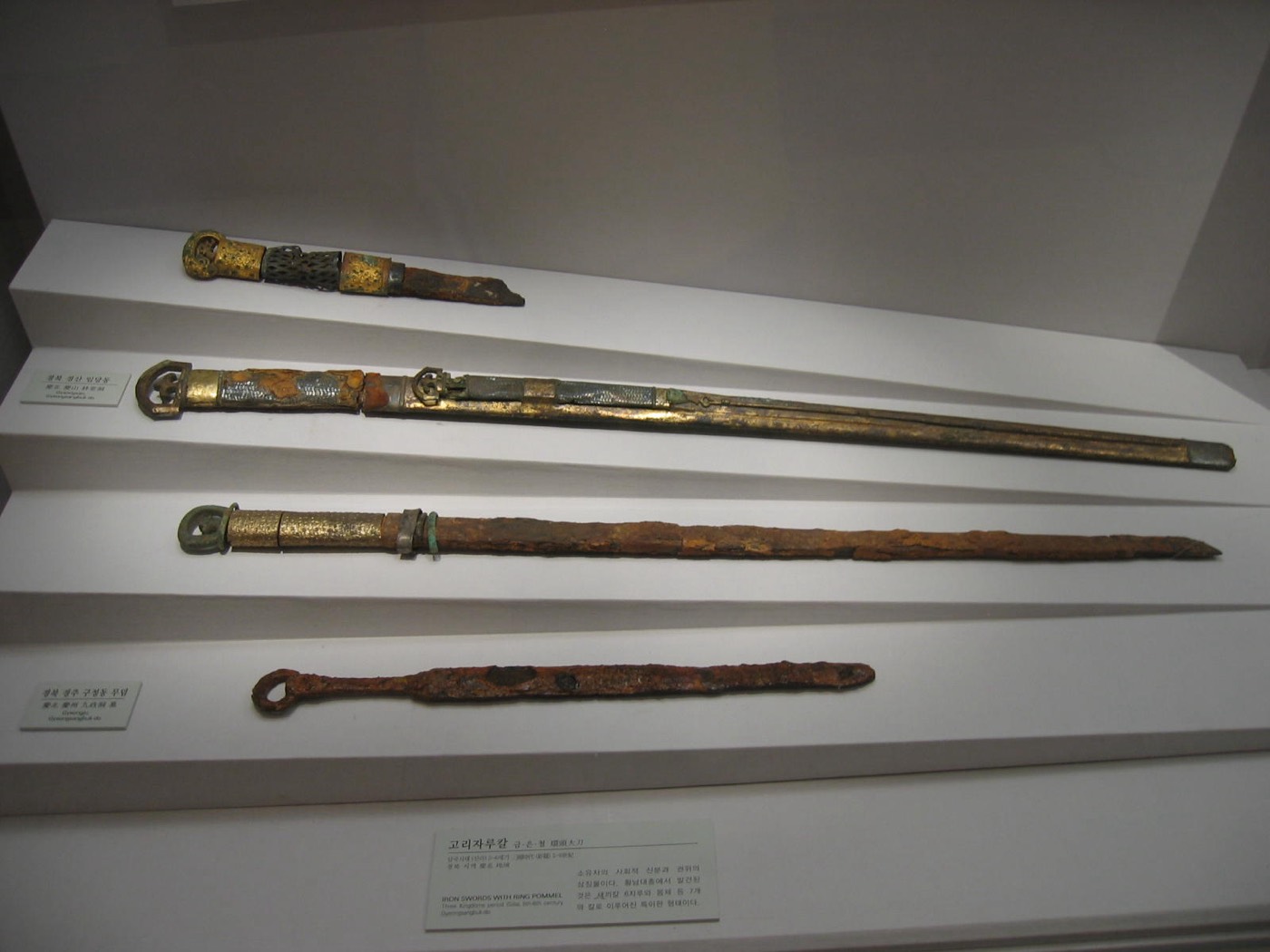 Iron swords with ring pommels from Silla tombs in the National Museum of Korea. The ring-pommel sword (hwandu daedo) was the standard straight sword of all three kingdoms, carried at the hip; decorated rings marked rank.