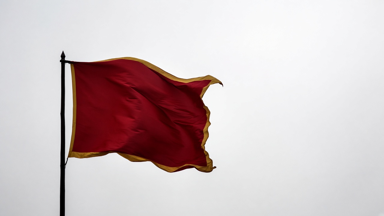 Single Tang banner flag in wind with gold accent - minimal iconic symbol of Tang imperial authority and pageantry